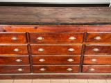 a large wooden dresser with many drawers and knobs