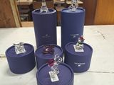 a table with a bunch of purple containers on it