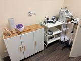 an image of a room with a table, cabinets, and a sewing machine