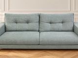 an image of a blue couch sitting on top of a hard wood floor