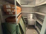 a room with a lot of boxes and chairs in it