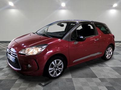 the red citrole is parked on a checkered tile floor