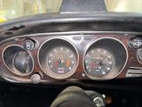 a close up of a dashboard of a car with gauges