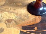 a vase sitting on top of a table on a wooden table