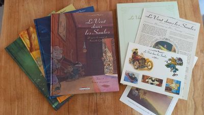 several books on a table with a wooden table top