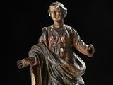 an old statue of a woman with a robe and a robe around her neck