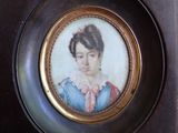 a picture of a woman in a blue dress in a gold frame