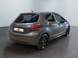 the back of a silver car in a room with a black floor