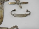 several different types of metal items are displayed on a white surface
