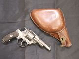 a gun and a leather case on a black background
