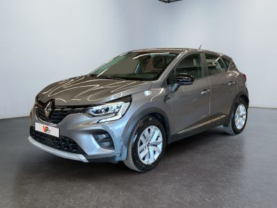 a grey car parked in a showroom with white walls