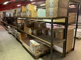 boxes are stacked on a shelf in a warehouse with a red roof