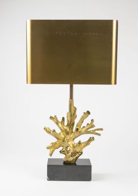 a brass table lamp with a square shade on top of it