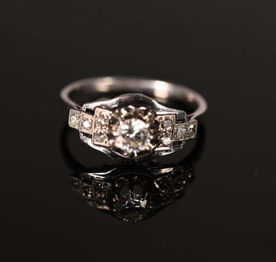 a close up of a diamond ring on a black surface