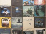 a lot of different album covers on the wall