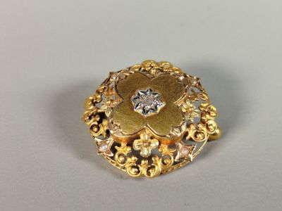 a close up of a gold ring with a diamond in the center