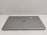 the laptop is sitting on a white table with a white background