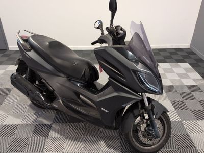 a black motorcycle that is parked on a checkered floor