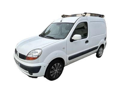 the small white van is parked on the side of the road