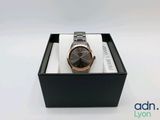 gros plan d'une montre dans une boîte sur une surface blanche
