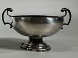 a silver bowl sitting on top of a silver pedestal