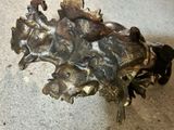a bronze sculpture of a horse and a horse head on the ground
