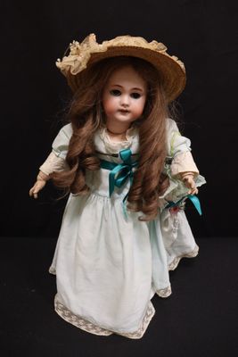 a doll that is wearing a hat and dress