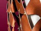 a close up of a piece of leather with a chain hanging from it