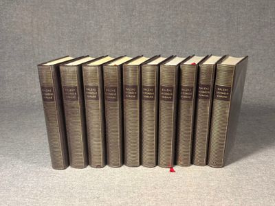 a set of five books sitting on top of each other on a table