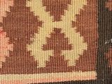 a close up of a rug with a brown and yellow design