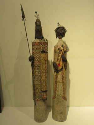 two statues that are on display on a table