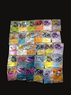 a pile of pokemon cards on a black background
