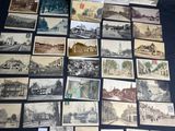 many old postcards of different types and sizes are on a table