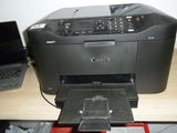 a printer sitting on a desk next to a laptop