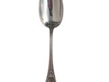 silver plated spoon on a white background with a reflection of the spoon