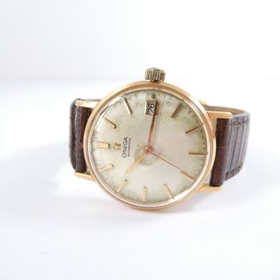 a watch that is sitting on a white surface