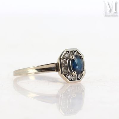 a close up of a ring with a blue stone in it