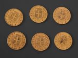 six different types of gold coins on a black surface