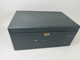 a black box with a lock on top of it on a white surface