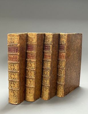 three old books sitting on top of each other on a table