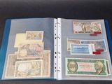 a binder with a lot of different currency on it