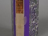 an old book with a purple cover sitting on top of a table