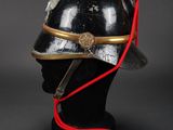an old helmet with a red cord attached to the side of it