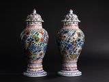 pair of chinese vases on a black background with a dark background
