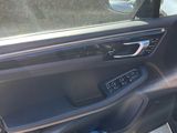 the interior of a car with the door open and the driver ' s seat up