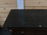 an image of a black granite top dresser
