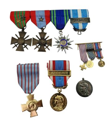 many medals and medals on display on a white background