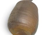 a brown vase on a white surface with a white background