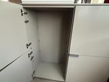 a white refrigerator in the corner of a room