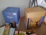 a box of books sitting on a table next to a box of books